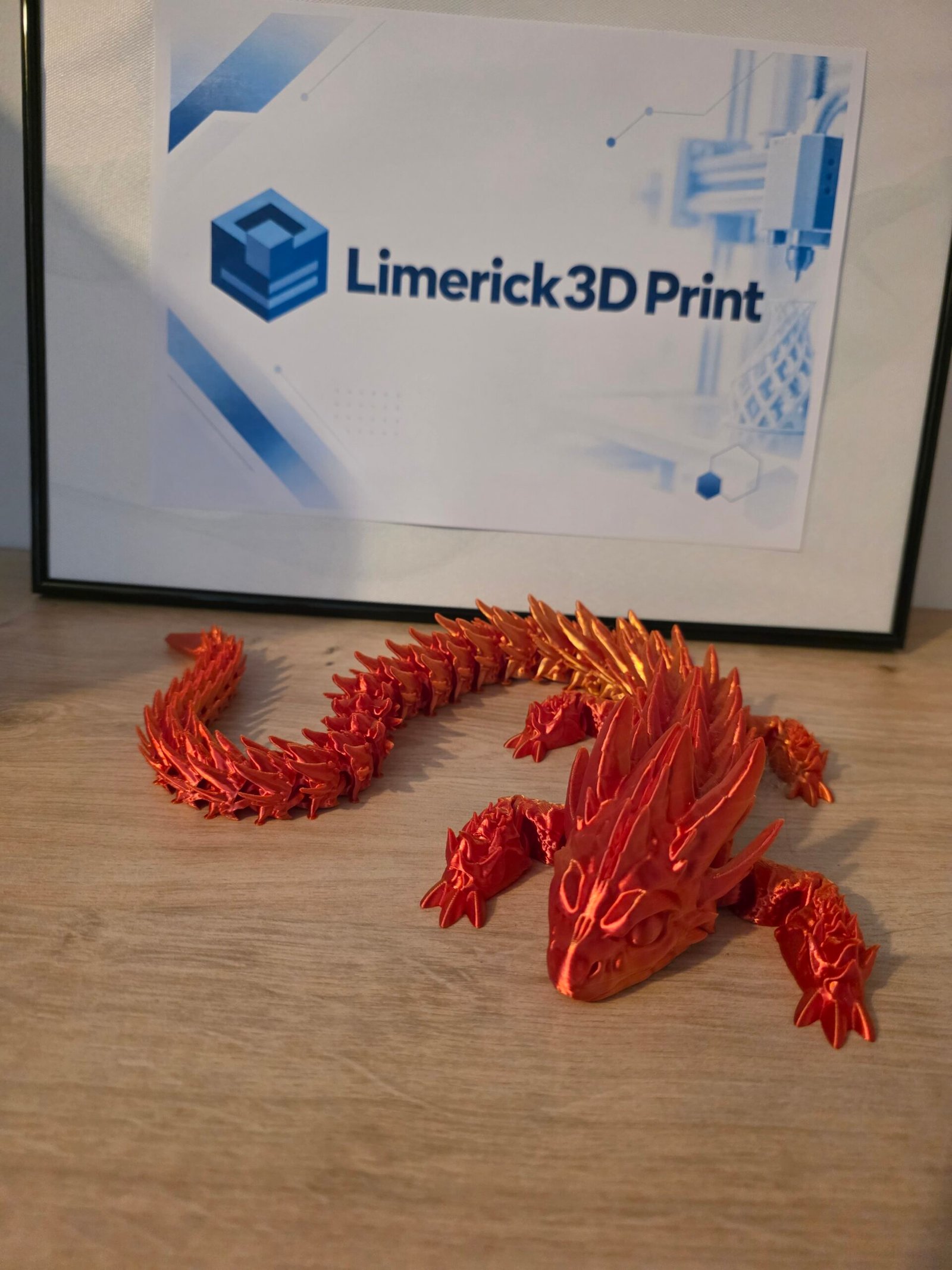 Red and gold articulated Crystal Dragon with Limerick 3D Print logo
